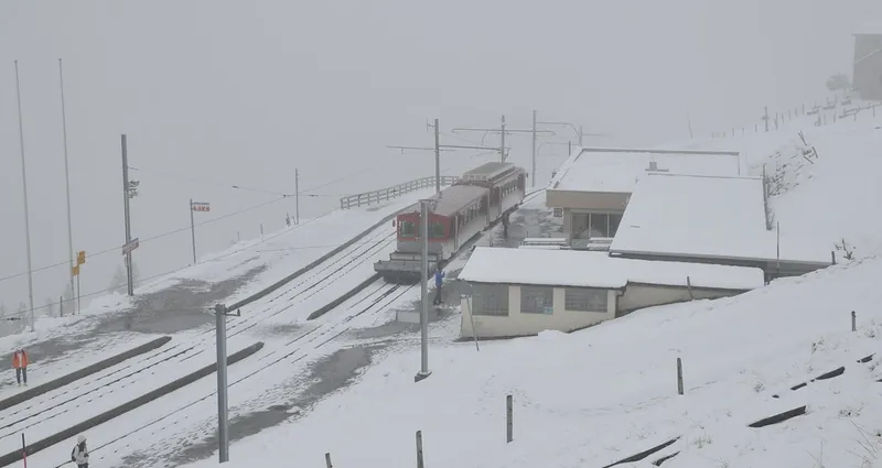 Rigi Kulm summit, a train departs in snowy conditions