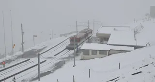 Rigi Kulm summit, a train departs in snowy conditions