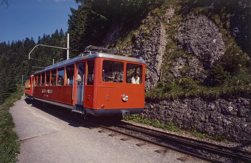 Vitznau-Rigi Railway (VRB) Bhe 2/4 railcar No. 2 with a lead car on an open stretch of track (1975)